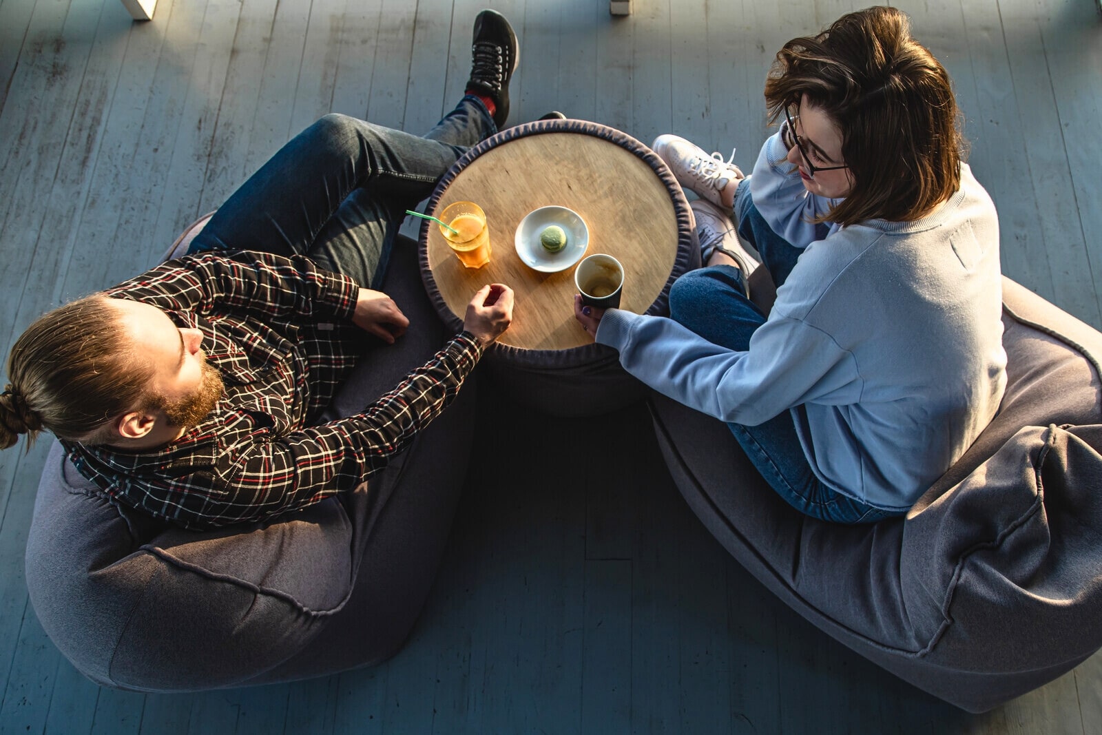 man and woman sitting on beanbags having a deep conversation