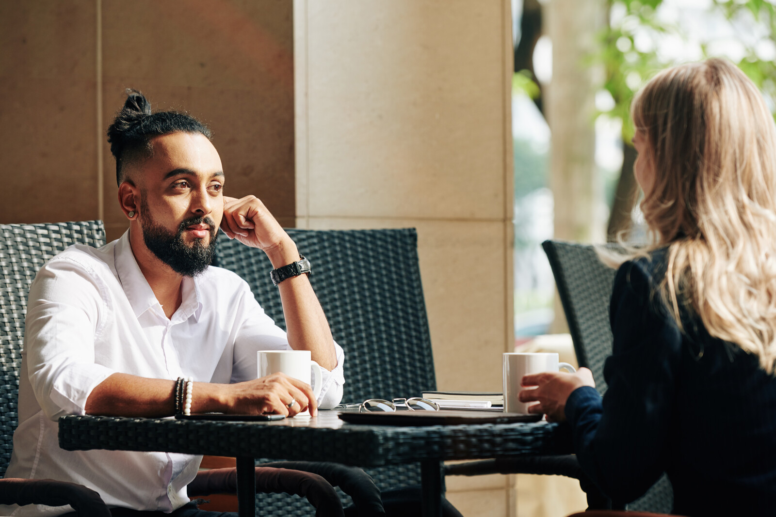 man and woman talking in a cafe