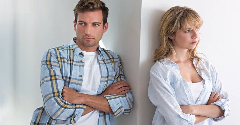 couple with crossed arms involved in a circular argument in their relationship