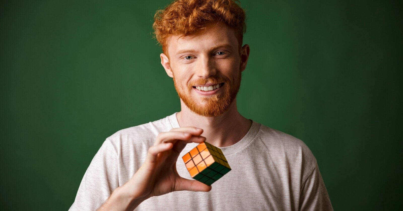 man who is a good problem-solver holding a Rubik's Cube