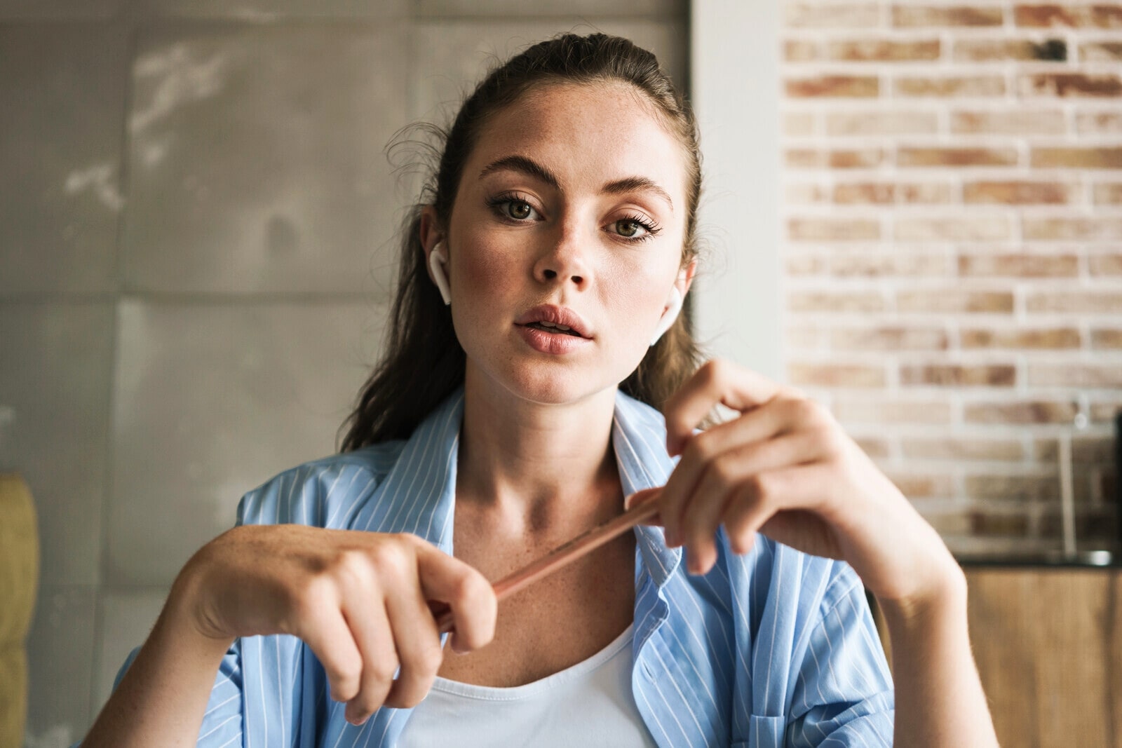 introvert woman studying at home with earbuds in