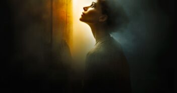 A woman stands in a dark, smoky room, gazing upward toward a bright, warm light streaming through a slightly open door, illuminating her face and silhouette.